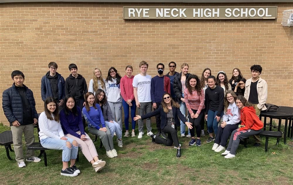  ILP students stand in front of the Rye Neck High School sign with mentor Dr. Valerie Feit. 